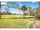 Scenic view of a sprawling golf course with lush green fairways and mature trees in the background at 401 Walls Way, Osprey, FL 34229