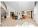 Open-concept living room with hardwood floors, a fireplace, and a spiral staircase at 401 Walls Way, Osprey, FL 34229