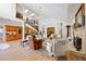 Elegant living room with high ceilings, wood floors, fireplace, and staircase at 401 Walls Way, Osprey, FL 34229