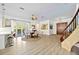 Airy living room with hardwood floors, dining area, and access to the outdoor patio at 401 Walls Way, Osprey, FL 34229