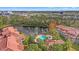 Aerial view of community pool and lake, showcasing the lush landscaping at 4990 Baraldi Cir # 101, Sarasota, FL 34235