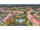 Aerial view of community with pool, lake, and multiple buildings at 4990 Baraldi Cir # 101, Sarasota, FL 34235