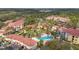 Aerial view of community pool, buildings, and lush landscaping at 4990 Baraldi Cir # 101, Sarasota, FL 34235