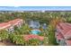 Aerial view of community pool, lake, and residential buildings at 4990 Baraldi Cir # 101, Sarasota, FL 34235