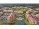 Aerial view of community with pool, lake, and multiple buildings at 4990 Baraldi Cir # 101, Sarasota, FL 34235