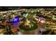 Nighttime aerial view of a shopping center with festive holiday lights at 4990 Baraldi Cir # 101, Sarasota, FL 34235