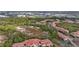 Aerial view of community, featuring a pond, tennis court, and numerous residential buildings at 4990 Baraldi Cir # 101, Sarasota, FL 34235