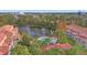 Community pool and lake view from above, surrounded by buildings at 4990 Baraldi Cir # 101, Sarasota, FL 34235