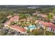 Community pool and surrounding buildings in an aerial view at 4990 Baraldi Cir # 101, Sarasota, FL 34235