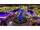 Aerial view of a shopping center decorated for the holidays with twinkling lights at 4990 Baraldi Cir # 101, Sarasota, FL 34235