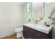 Contemporary bathroom with a sleek vanity and an oval mirror at 4990 Baraldi Cir # 101, Sarasota, FL 34235