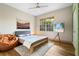 Spacious bedroom with a wooden bed frame and large window at 4990 Baraldi Cir # 101, Sarasota, FL 34235