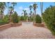 Tranquil courtyard with a central fountain and patterned tile at 4990 Baraldi Cir # 101, Sarasota, FL 34235