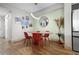 Modern dining area with wood table and red chairs at 4990 Baraldi Cir # 101, Sarasota, FL 34235