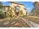 Tan two-story townhome with red garage doors and walkway at 4990 Baraldi Cir # 101, Sarasota, FL 34235