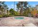 Relaxing hot tub surrounded by a brick patio and lounge chairs at 4990 Baraldi Cir # 101, Sarasota, FL 34235