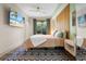 Spacious main bedroom with king bed and access to a balcony at 4990 Baraldi Cir # 101, Sarasota, FL 34235