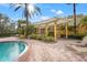 Relaxing pool area with pergola, lounge chairs, and lush landscaping at 4990 Baraldi Cir # 101, Sarasota, FL 34235