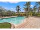 Inviting community pool with lounge chairs and a pergola at 4990 Baraldi Cir # 101, Sarasota, FL 34235