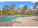 Large, inviting resort-style pool with surrounding patio and palm trees at 4990 Baraldi Cir # 101, Sarasota, FL 34235