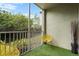 Relaxing screened balcony with artificial turf and outdoor seating at 4990 Baraldi Cir # 101, Sarasota, FL 34235