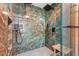 Large walk-in shower with marble tile and dual shower heads at 4990 Baraldi Cir # 101, Sarasota, FL 34235