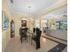 Formal dining room with glass table and view to living room at 521 Luminary Blvd, Osprey, FL 34229