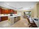 Kitchen with island, hardwood cabinets, and stainless steel appliances at 521 Luminary Blvd, Osprey, FL 34229