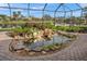 Enclosed patio with a lovely koi pond and waterfall feature at 521 Luminary Blvd, Osprey, FL 34229