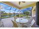 Covered patio with seating area overlooking a pond at 521 Luminary Blvd, Osprey, FL 34229