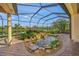 Relaxing screened patio with a pond and waterfall feature at 521 Luminary Blvd, Osprey, FL 34229