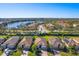 Aerial view of luxury homes with lake and lush landscaping at 6870 Willowshire Way, Bradenton, FL 34212