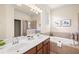 Elegant bathroom features a double sink vanity, a soaking tub, and a walk-in shower at 6870 Willowshire Way, Bradenton, FL 34212