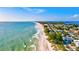 Aerial view of beachfront homes and a sandy beach at 6870 Willowshire Way, Bradenton, FL 34212