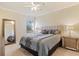 Comfortable bedroom with a queen-size bed and large mirror at 6870 Willowshire Way, Bradenton, FL 34212