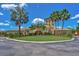 Luxury clubhouse with palm trees and landscaping at 6870 Willowshire Way, Bradenton, FL 34212