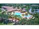 Aerial view of the community pool with palm trees, lounge chairs, and various water features at 6870 Willowshire Way, Bradenton, FL 34212