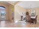 Spacious dining room with a large wooden table and chandelier at 6870 Willowshire Way, Bradenton, FL 34212