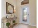 Elegant entryway with a decorative console table and stained glass door at 6870 Willowshire Way, Bradenton, FL 34212