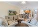 Bright living room features comfortable seating and a view into the kitchen at 6870 Willowshire Way, Bradenton, FL 34212