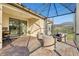 Covered patio featuring a comfortable seating area, a grill, and a view of the outdoor landscaping and pool area at 6870 Willowshire Way, Bradenton, FL 34212