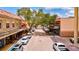 View down a tree-lined street with parked cars and shops at 6870 Willowshire Way, Bradenton, FL 34212