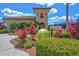 Exterior view of the community tennis center surrounded by colorful plants and landscaping features at 6870 Willowshire Way, Bradenton, FL 34212