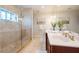 Bathroom features a walk-in shower, double vanity, and stained glass window at 3816 6Th Ave, Holmes Beach, FL 34217