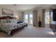 Main bedroom with king-size bed and access to a balcony at 3816 6Th Ave, Holmes Beach, FL 34217