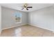 Bright bedroom with tile floors and ceiling fan at 5271 Beckham St, North Port, FL 34288