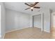 Bedroom with tile floors, ceiling fan, and double-door closet at 5271 Beckham St, North Port, FL 34288