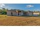 One story home with a red door and attached garage at 5271 Beckham St, North Port, FL 34288