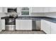 Modern kitchen with stainless steel appliances and dark countertops at 5271 Beckham St, North Port, FL 34288