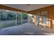 Screened porch with concrete floor and double doors at 5271 Beckham St, North Port, FL 34288